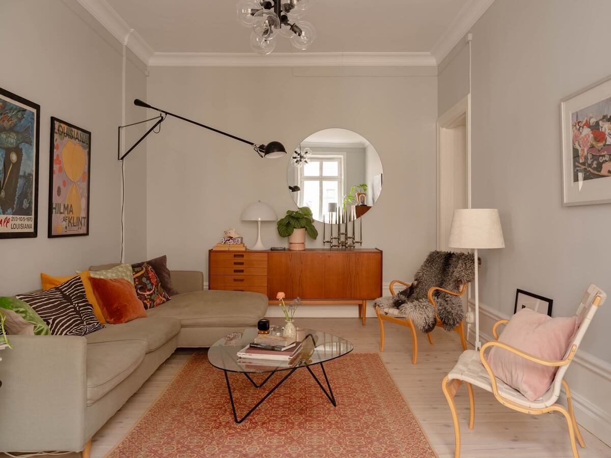 A Spacious Stockholm Apartment with Light Gray Walls 2 living room with round mirror light gray walls