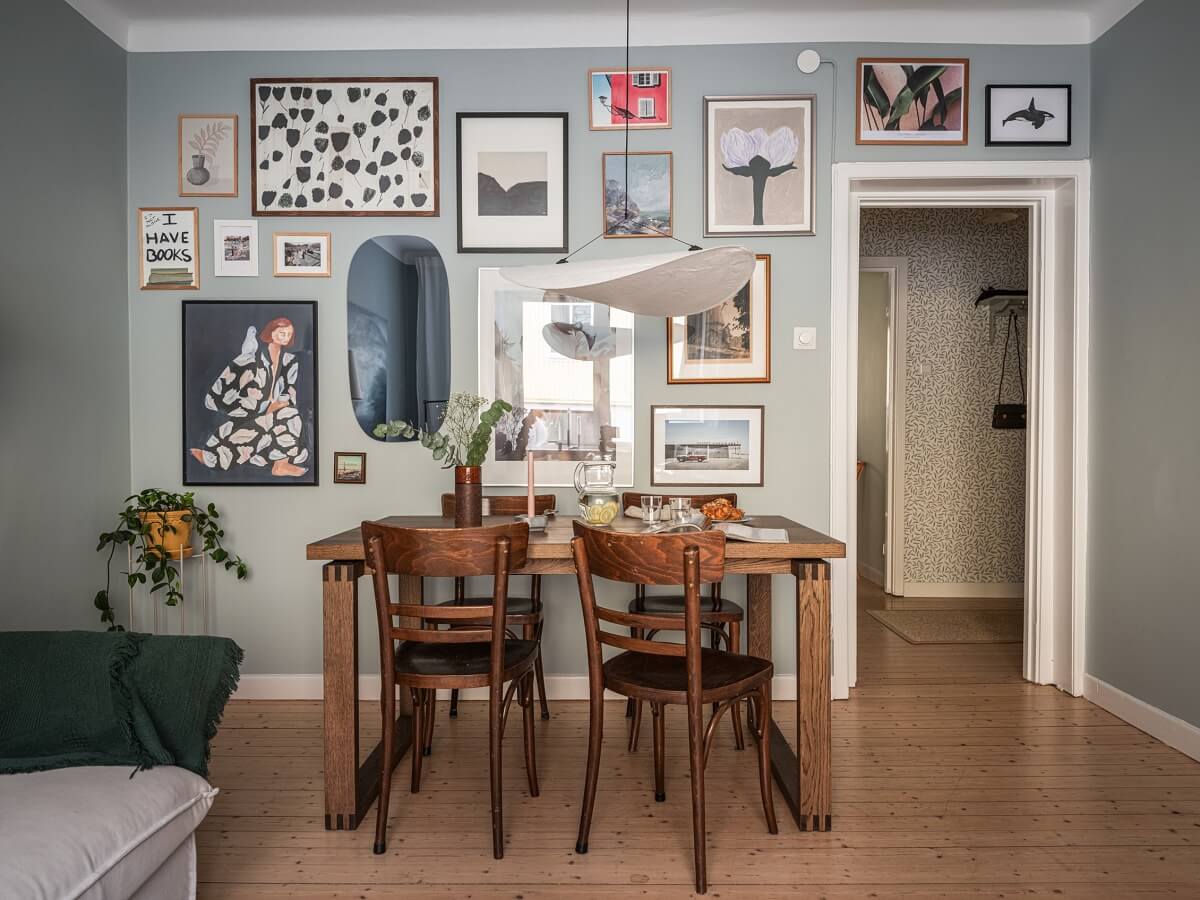 A 1930s Apartment with Gray Rooms and Period Features 4 living room with wooden table and gallery wall