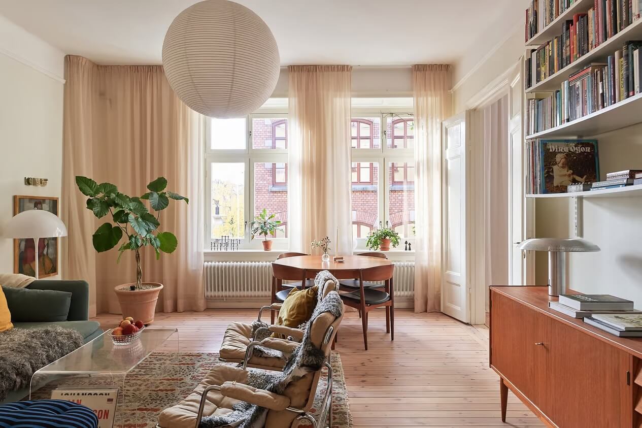 A Light Swedish Apartment with a Yellow Kitchen 1 living room wooden floor round table