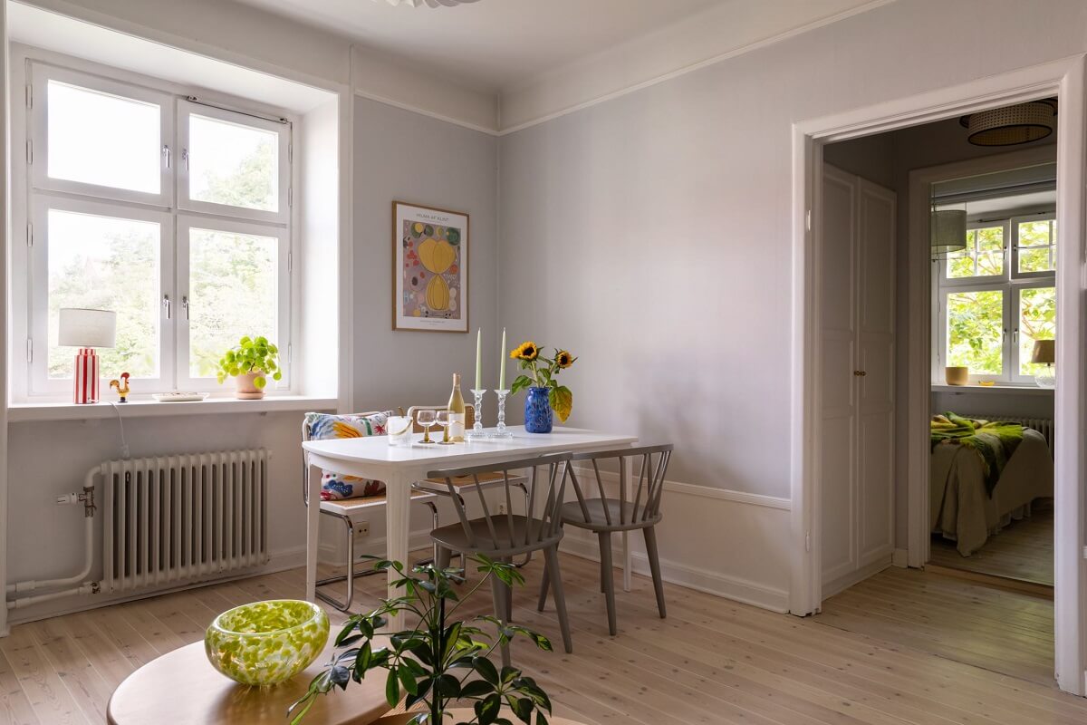 Soft Colors in a Charming Corner Apartment in Stockholm 7 living room wooden floorboards white dining table