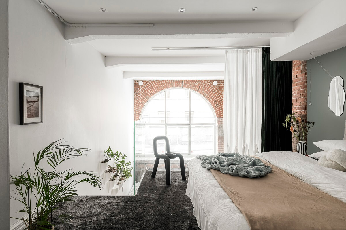 A Scandinavian Loft in an Old Industrial Building 15 loft bedroom arched window