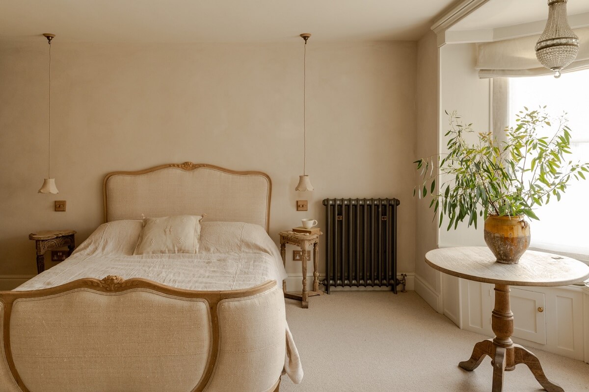 Limewash Walls and Restored Period Features in a Calm English Home 11 maste bedroom antique bed and bay window
