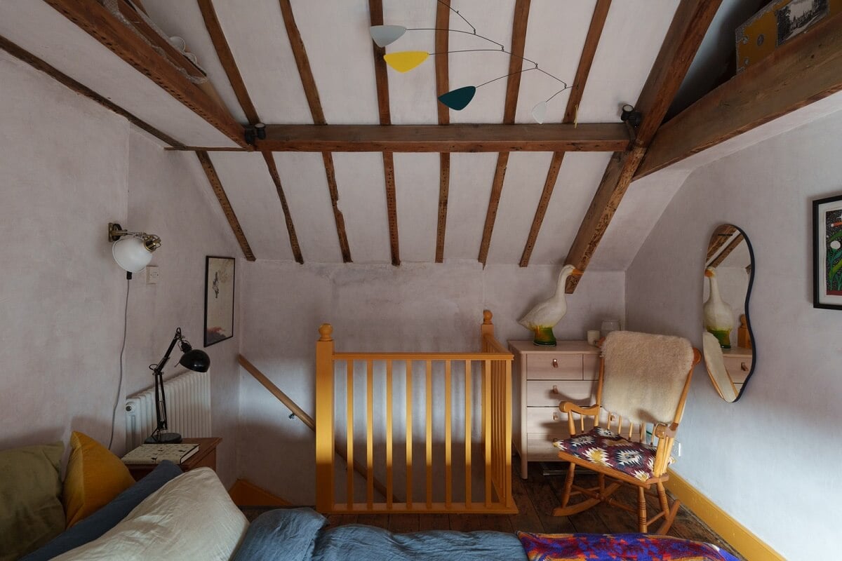 Colorful Furniture in a Historic English Cottage 16 master bedroom high pitched celing with wooden beams