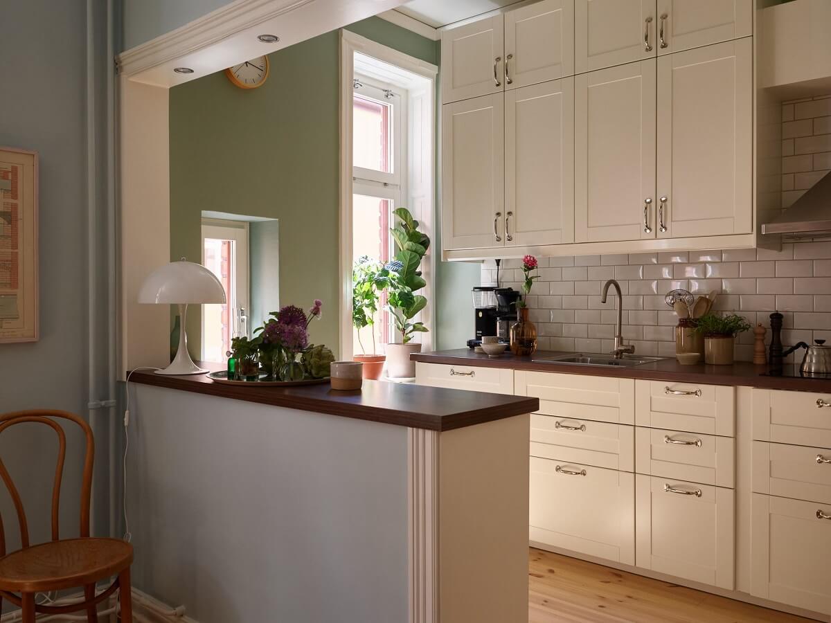 A Light Turn-of-the-Century Apartment with a Cheerful Color Palette 7 open kitchen with green walls