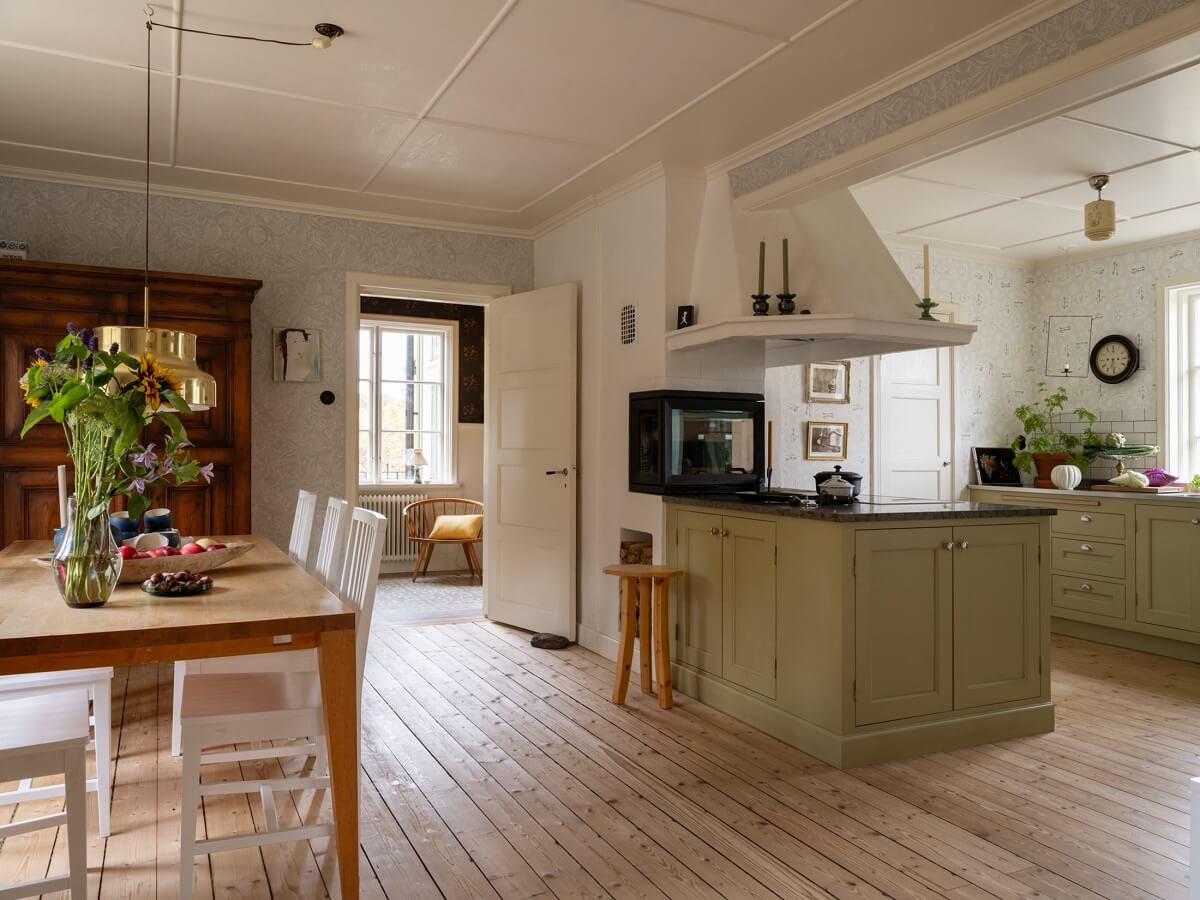open plan kitchen and dining room with wooden floorboards