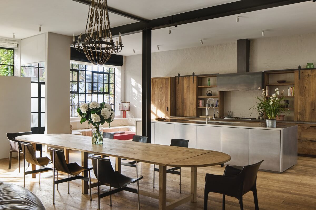 A Grand Industrial Warehouse Conversion in London 1 open plan kitchen stainless steel island large dining table