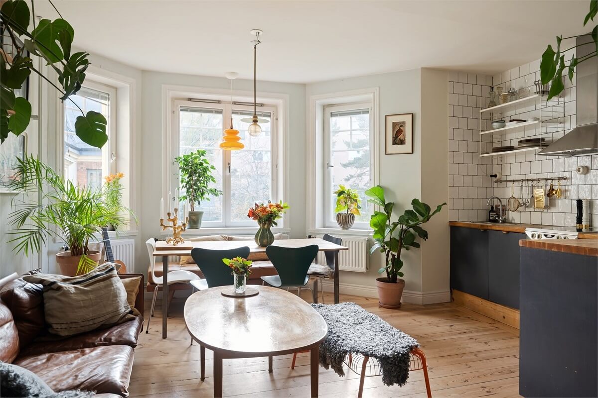 Green Tones in a Turn-of-the-Century Stockholm Apartment 2 open plan living room bay window plants