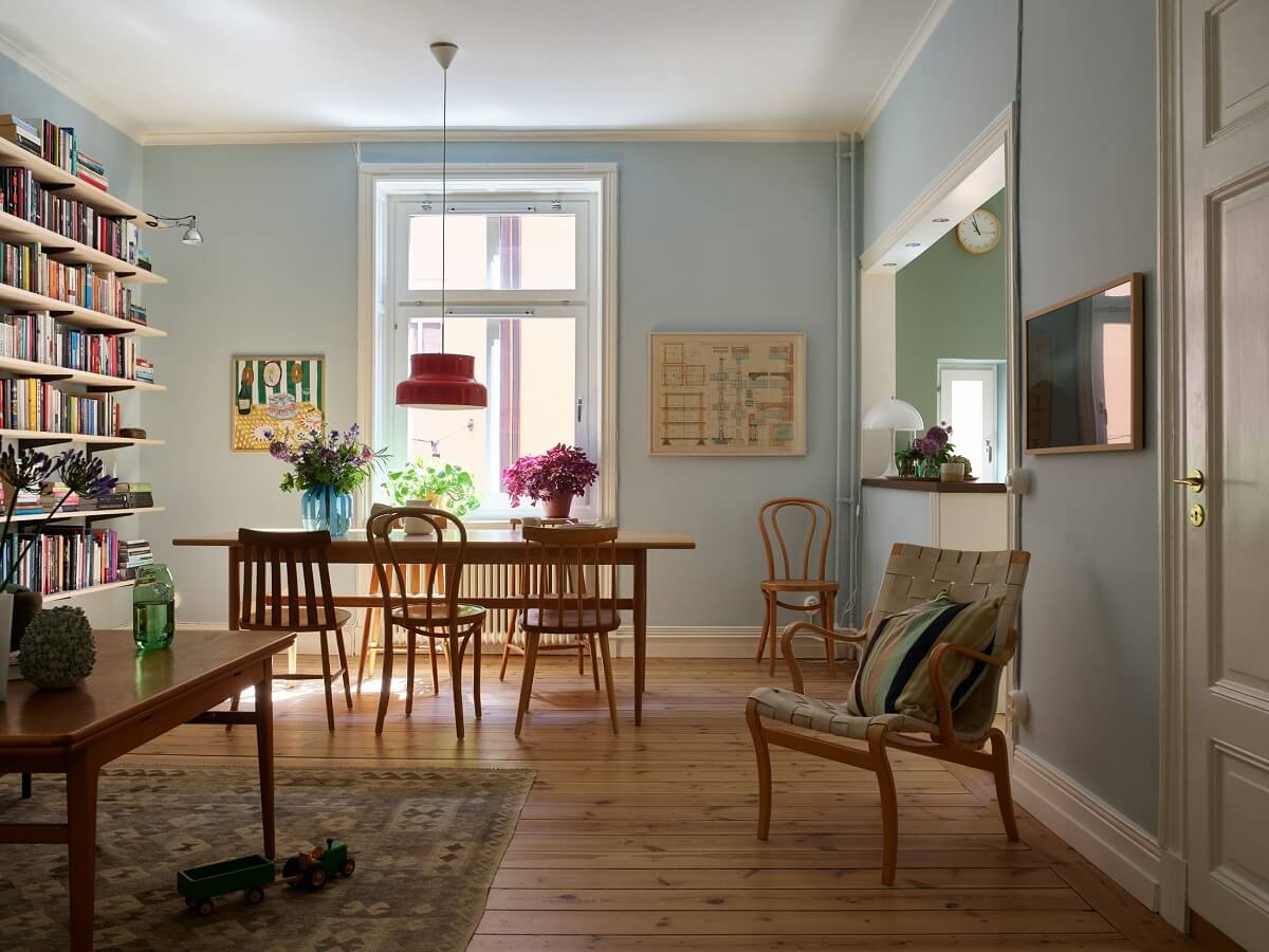 A Light Turn-of-the-Century Apartment with a Cheerful Color Palette 2 open plan living room light blue walls