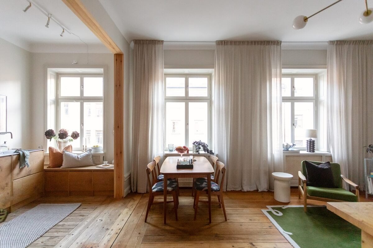 A Turn-of-the-Century Apartment with Warm Open-Plan Spaces 7 open plan living space with large windows