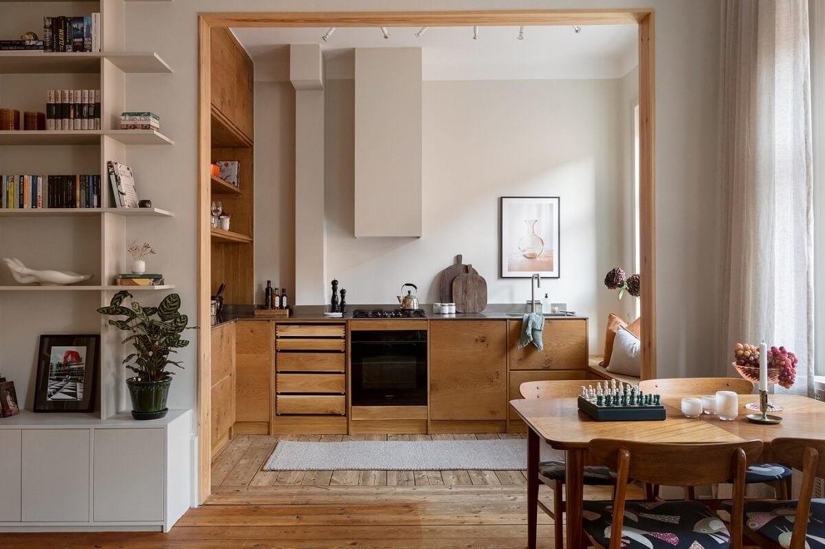 A Turn-of-the-Century Apartment with Warm Open-Plan Spaces 9 open plan living space with wooden kitchen