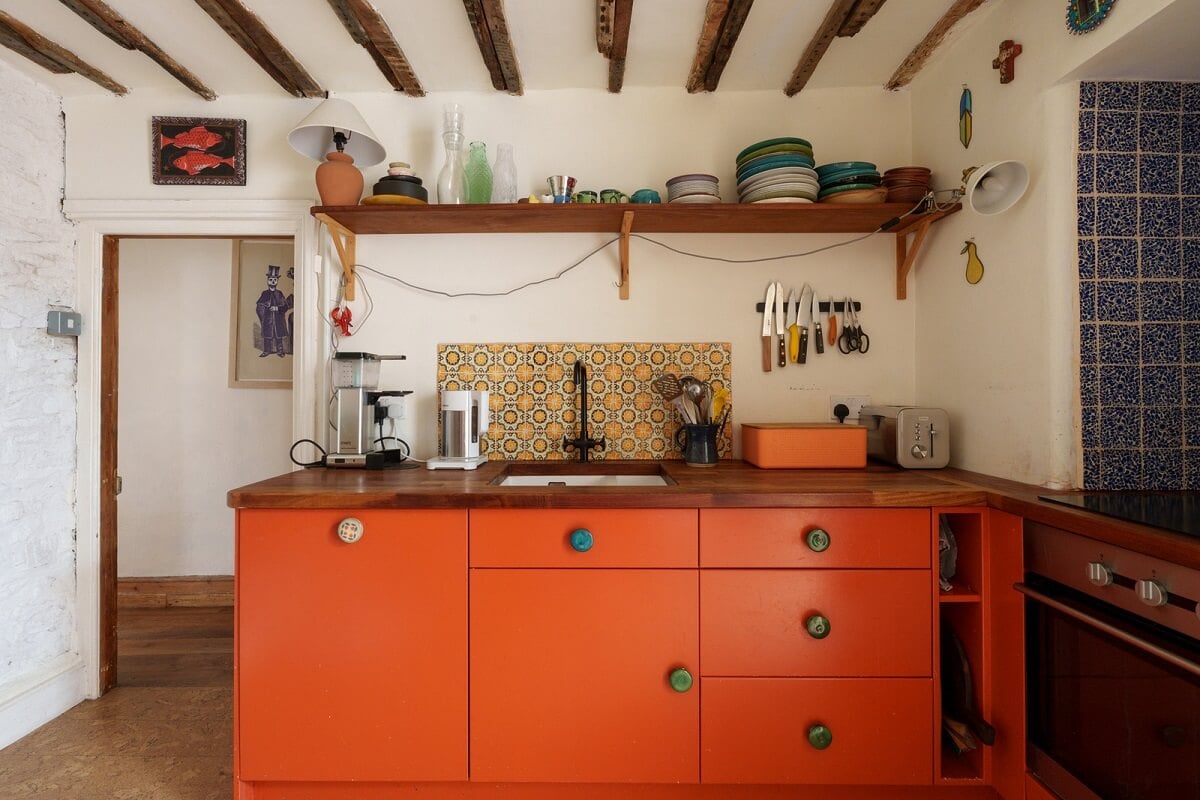 Colorful Furniture in a Historic English Cottage 7 orange kitchen cabinets