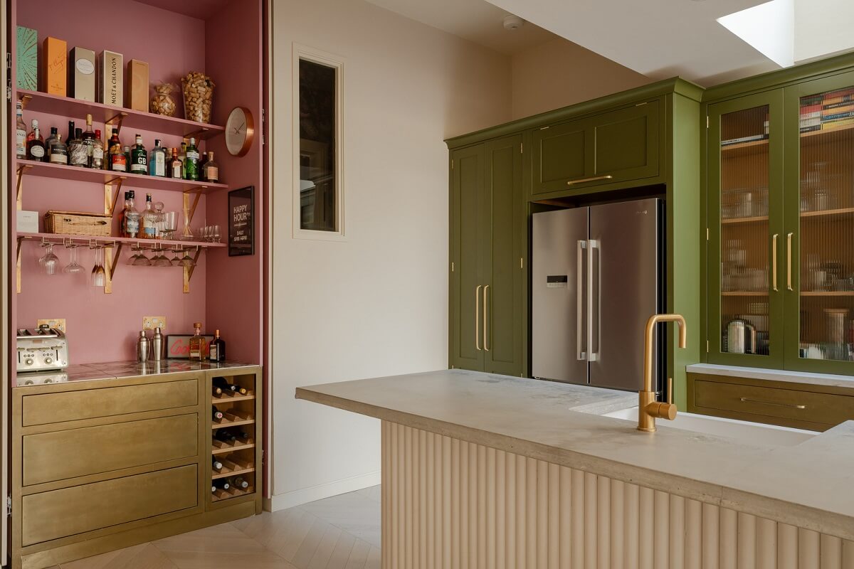 A Colorful Edwardian Family Home in London 8 pink and brass coffee corner and green kitchen cabinets