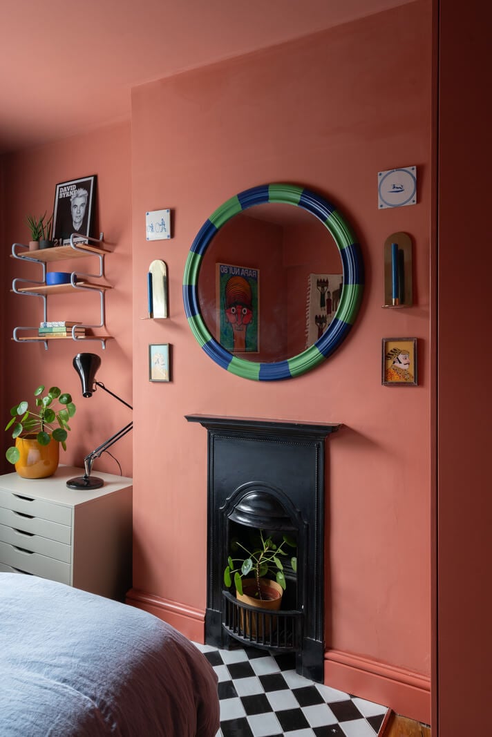 Colorful Rooms and Period Features in a London Terrace House 14 pink bedroom black fireplace checkerboard tiles