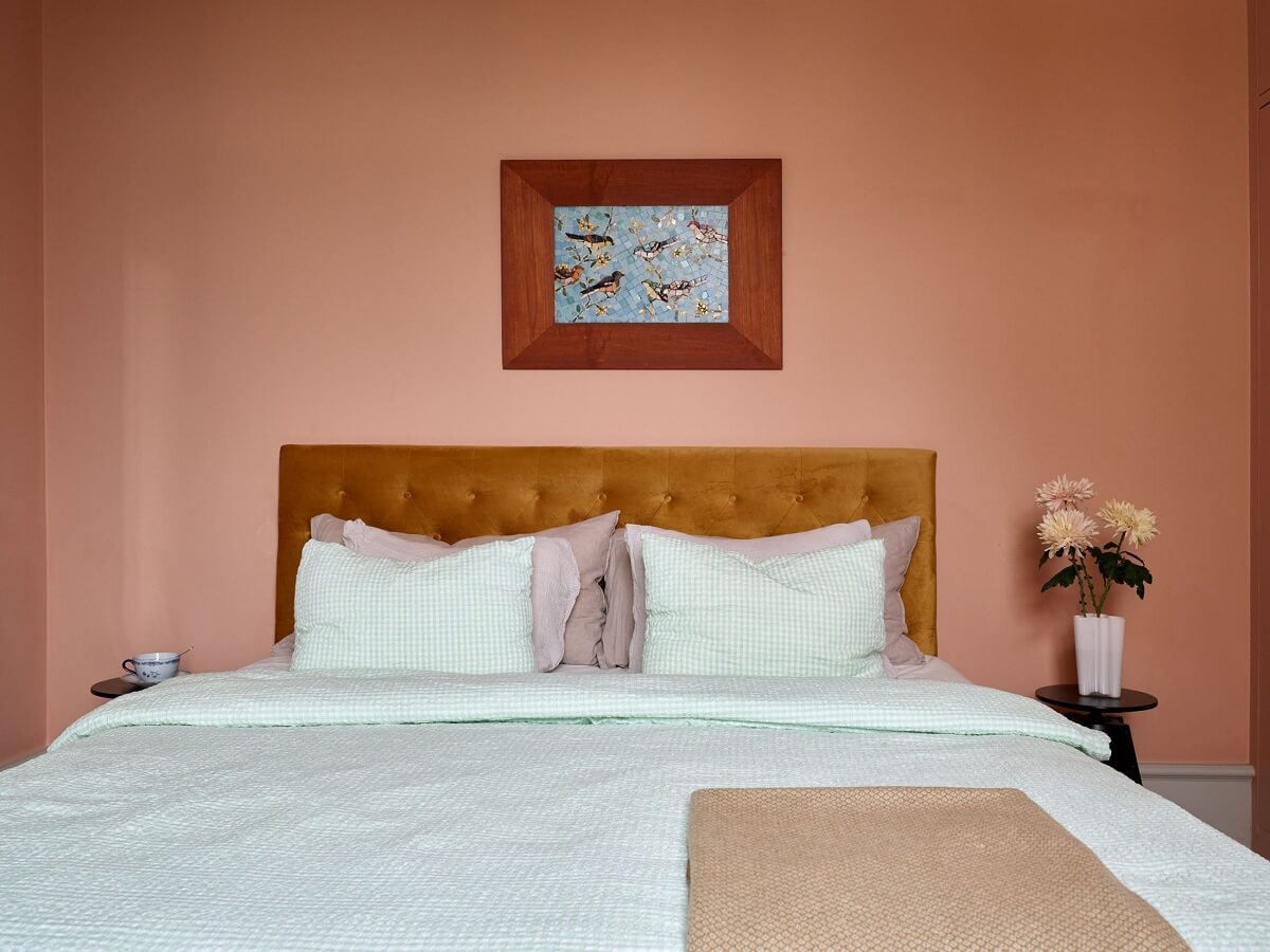 A Colorful Turn-of-the-Century Family Apartment in Stockholm 22 pink bedroom velvet ochre headboard