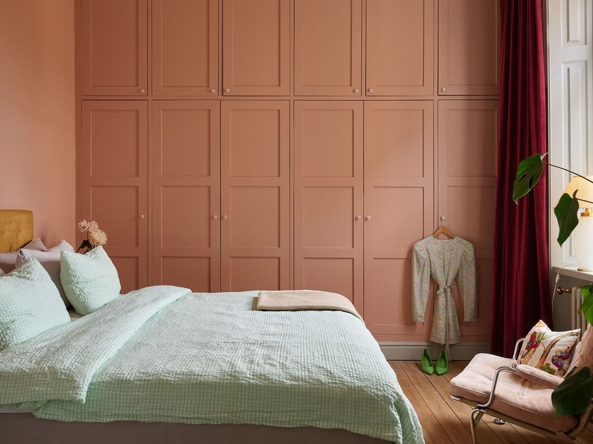 A Colorful Turn-of-the-Century Family Apartment in Stockholm 20 pink bedroom with floor to ceiling wardrobes