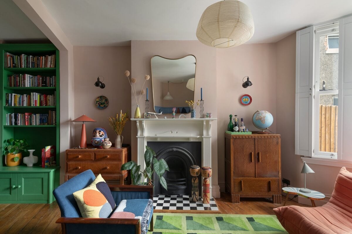 Colorful Rooms and Period Features in a London Terrace House 1 pink living room with firelace and bay window