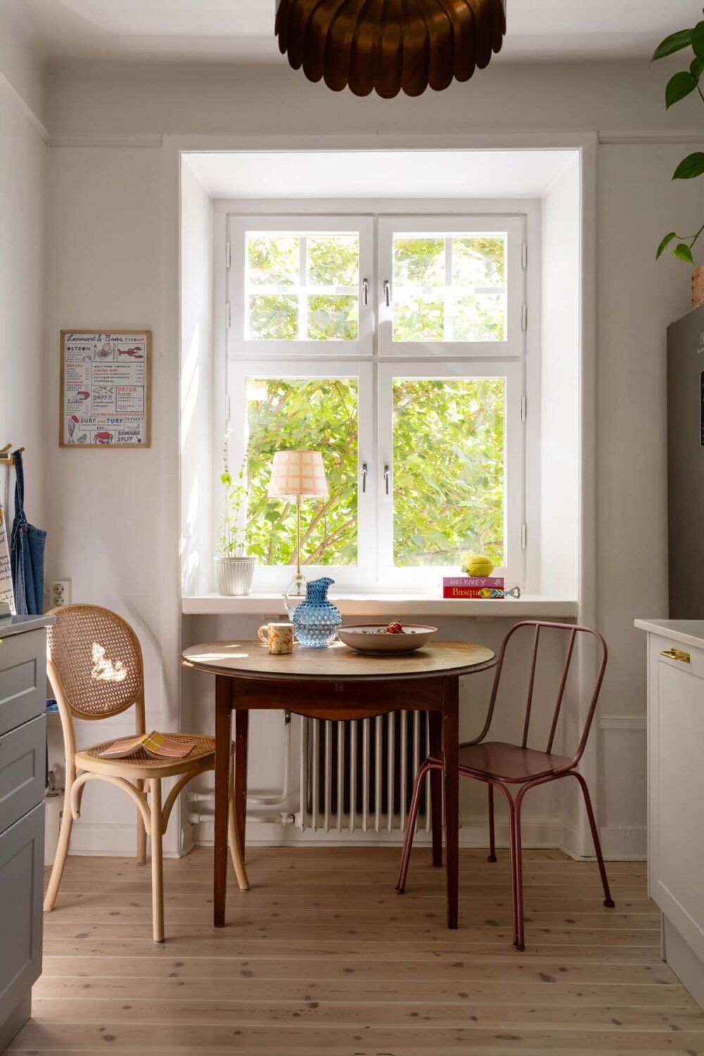 Soft Colors in a Charming Corner Apartment in Stockholm 17 round wooden kitchen table under window