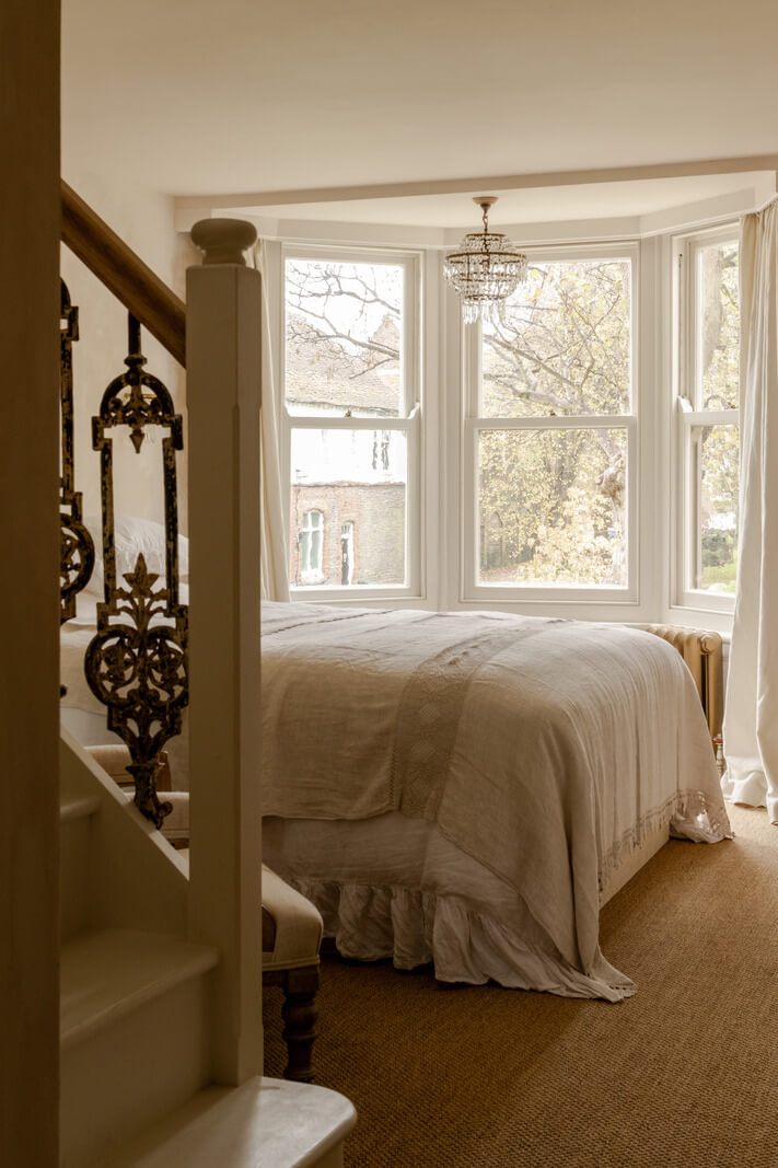 Serene Spaces with Limewash Walls in an English Victorian Home 13 serene limewash bedroom with bay window