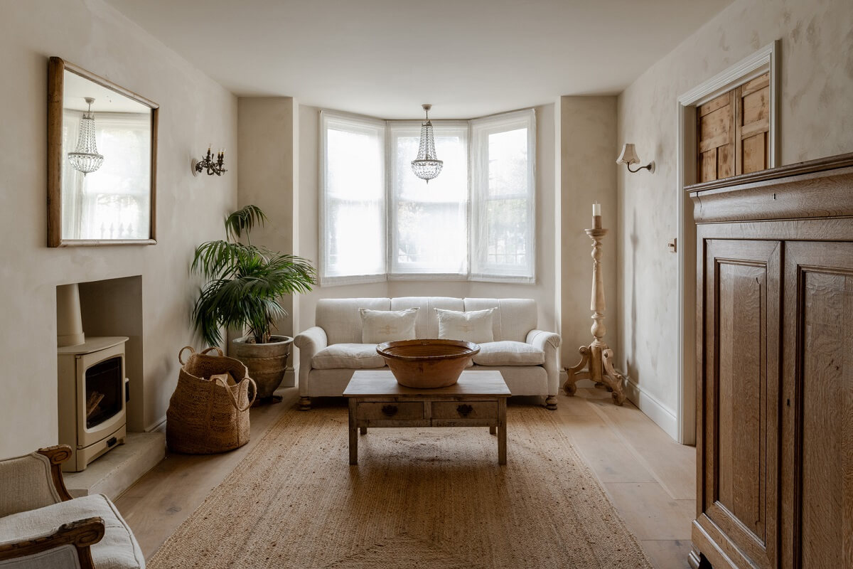 Limewash Walls and Restored Period Features in a Calm English Home 1 serene limewashed living room with bay window and woodburner