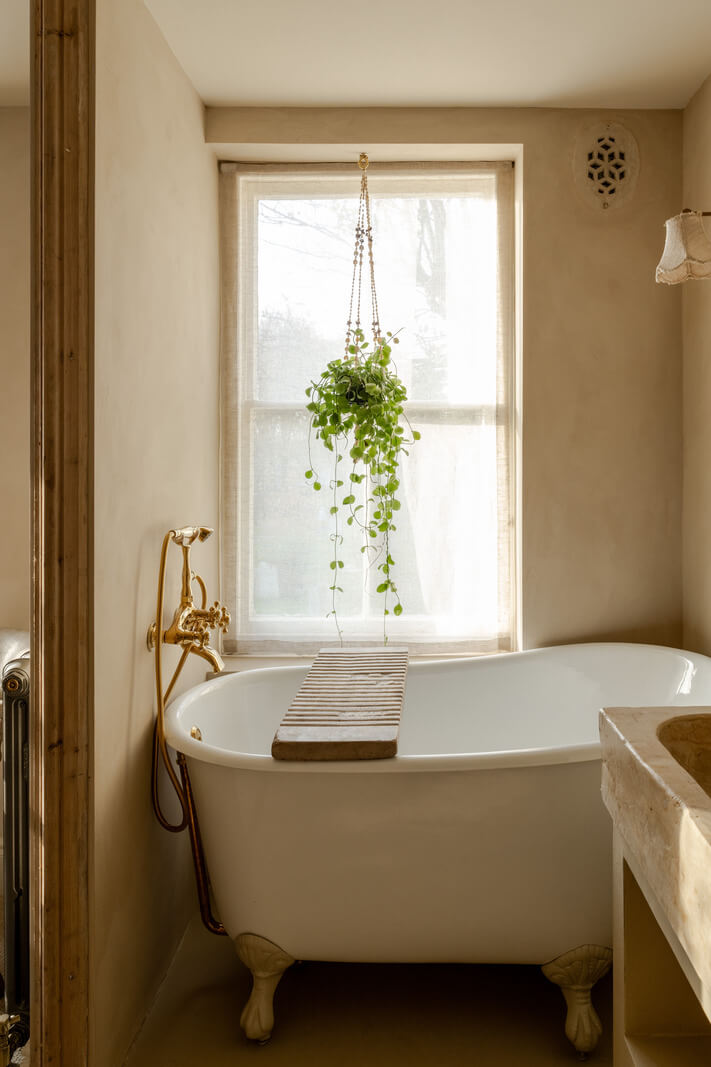 Limewash Walls and Restored Period Features in a Calm English Home 14 small freestanding bath under window
