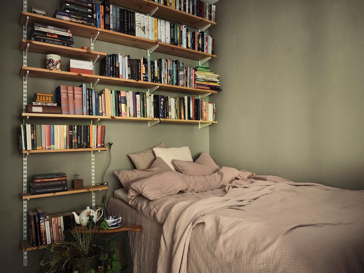 A Small Swedish Apartment with a Social and Semi-Open Floorplan 10 small green bedroom with bookshelves