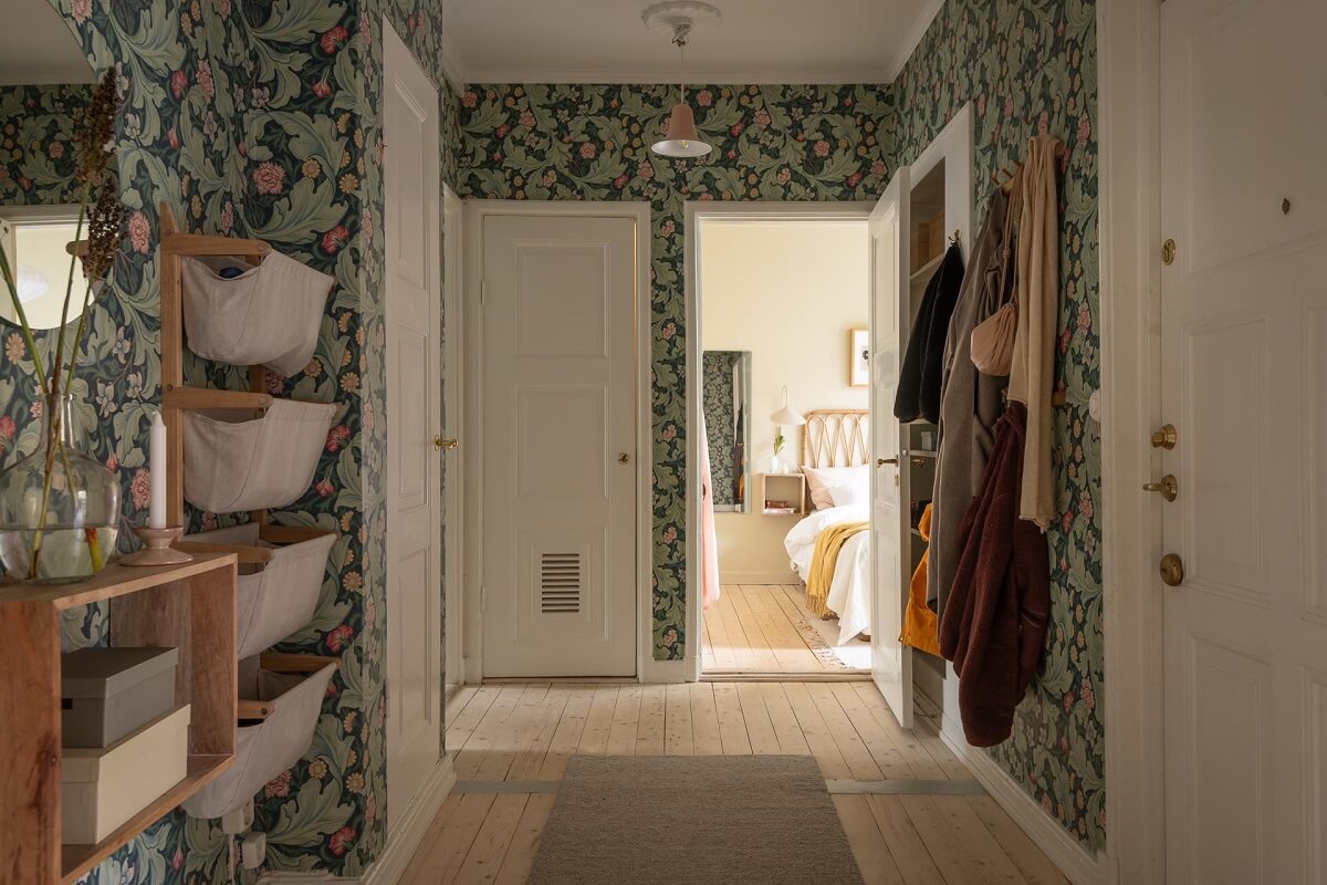 A Swedish Apartment Painted in Calm Beige, Green, and Pink Tones 28 storage basket hallway green wallpaper A Swedish Apartment Painted in Calm Beige, Green, and Pink Tones