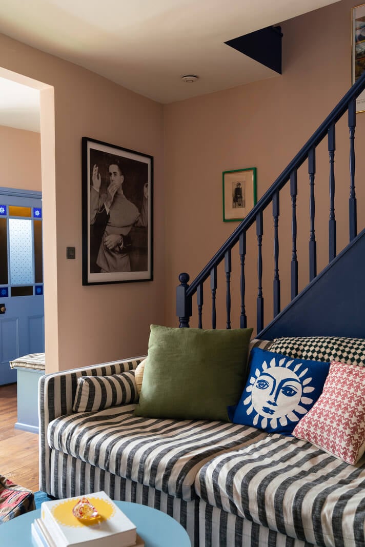 Colorful Rooms and Period Features in a London Terrace House 4 striped couch and blue staircase