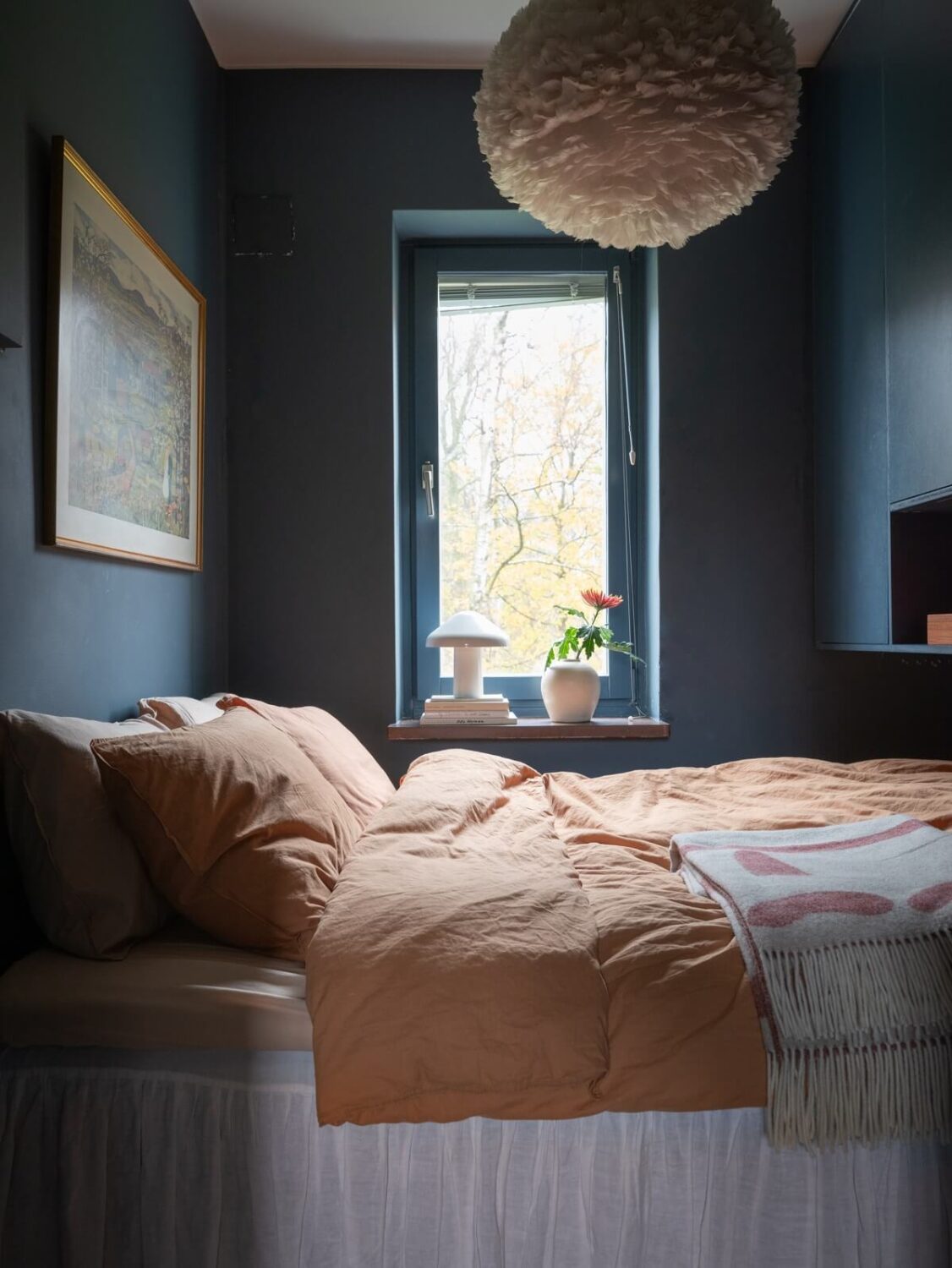 A Small Swedish Apartment with Dark Blue Walls 11 tiny dark blue bedroom with wall mounted storage