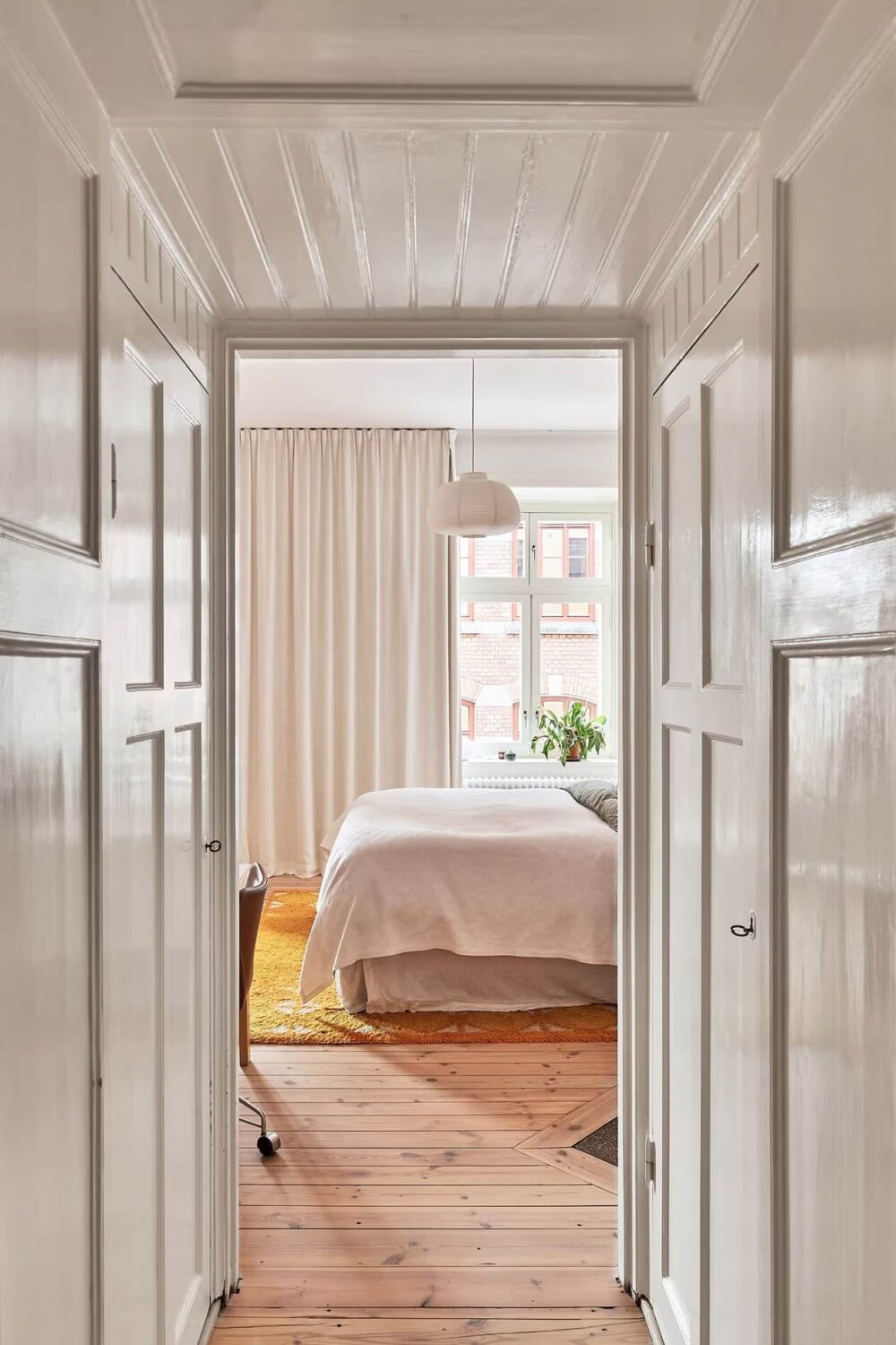 A Light Swedish Apartment with a Yellow Kitchen 13 view into bedroom