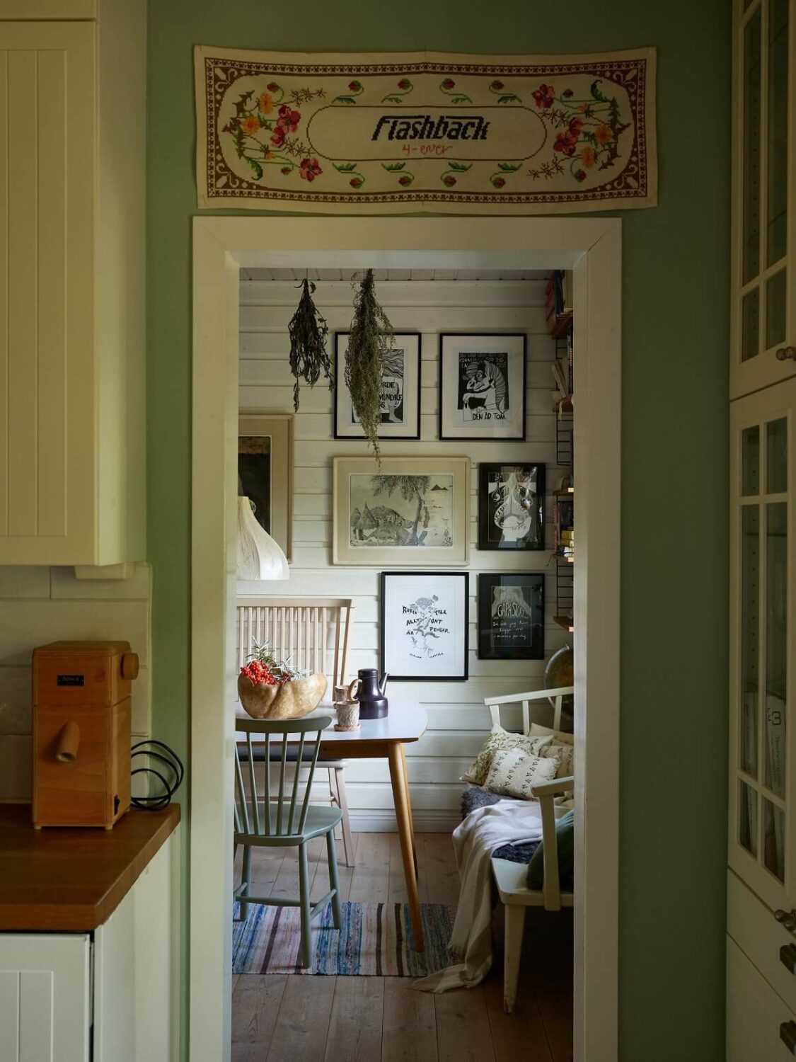 A Charming Swedish Cottage Filled with Art and Color 11 view into dining room
