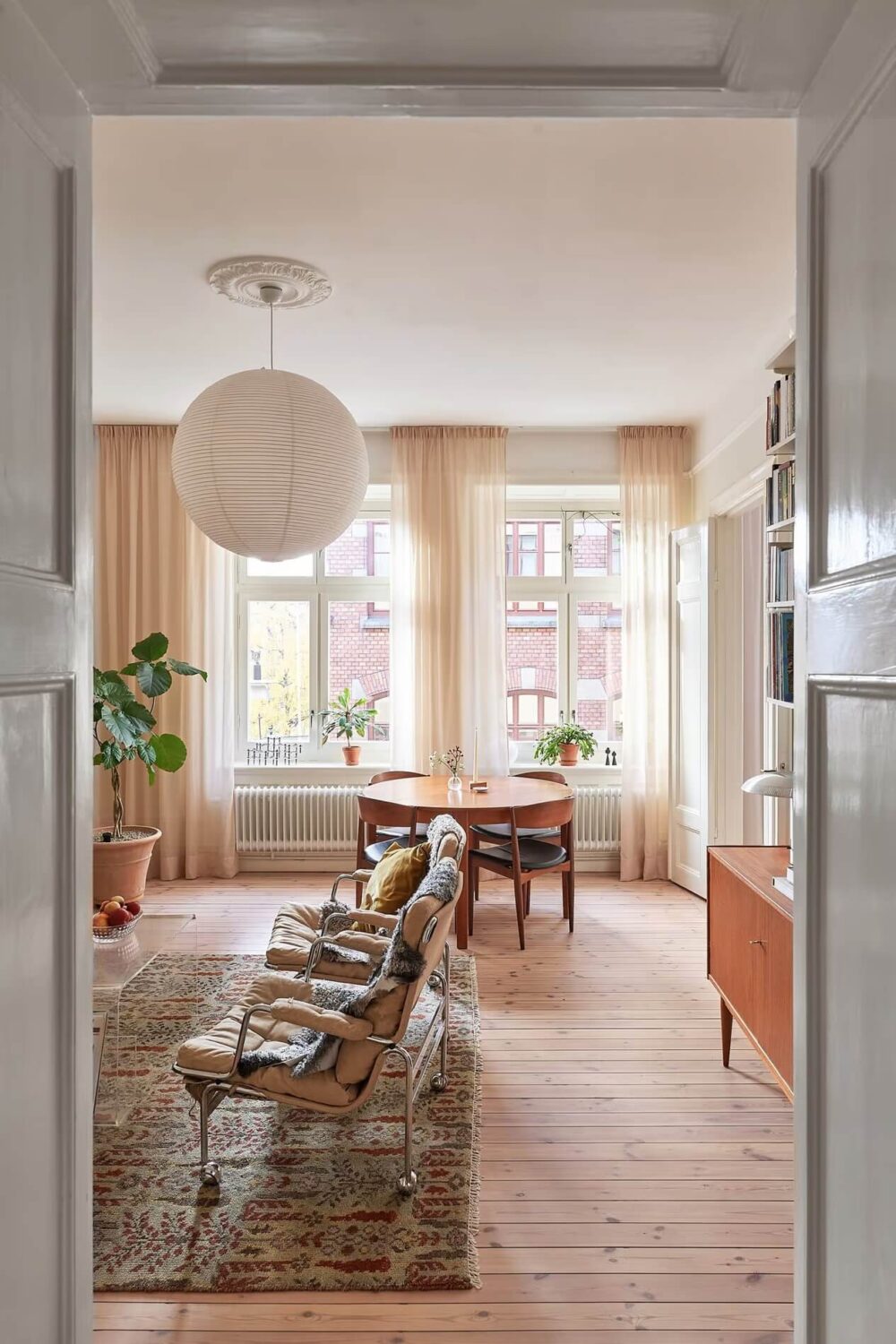 A Light Swedish Apartment with a Yellow Kitchen 7 view into living room