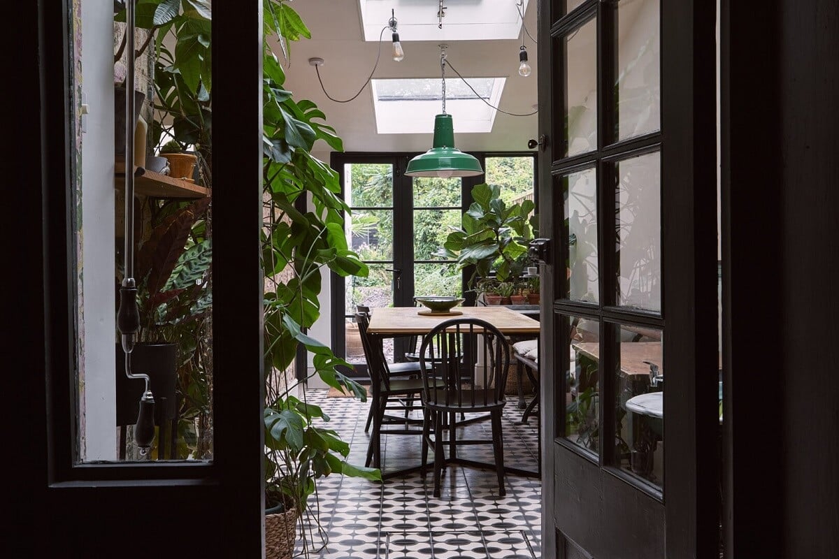 A Grand Victorian House with Many Period Features and a Lush Garden 9 view into plant filled dining room