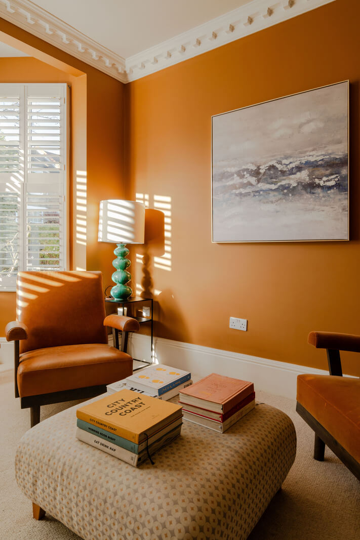 A Colorful Edwardian Family Home in London 3 warm orange walls bay window living room