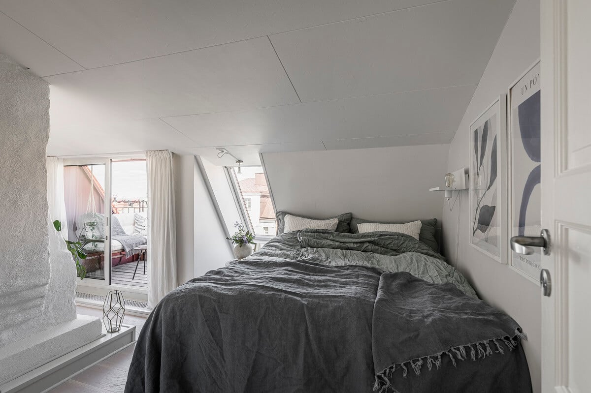 A Swedish Attic Apartment with a Lovely Balcony Overlooking the City 12 white attic bedroom with balcony