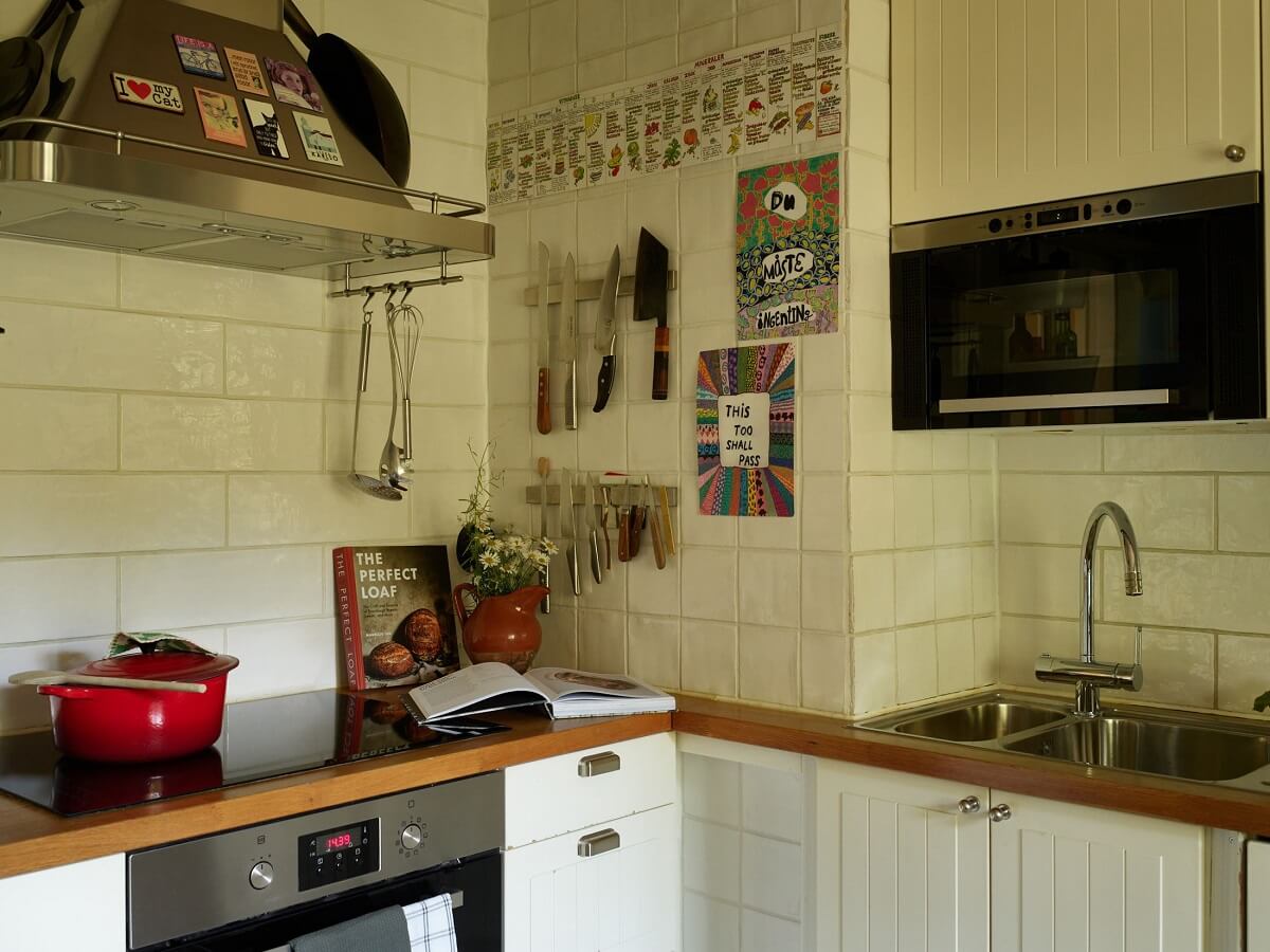 A Charming Swedish Cottage Filled with Art and Color 9 white cottage kitchen