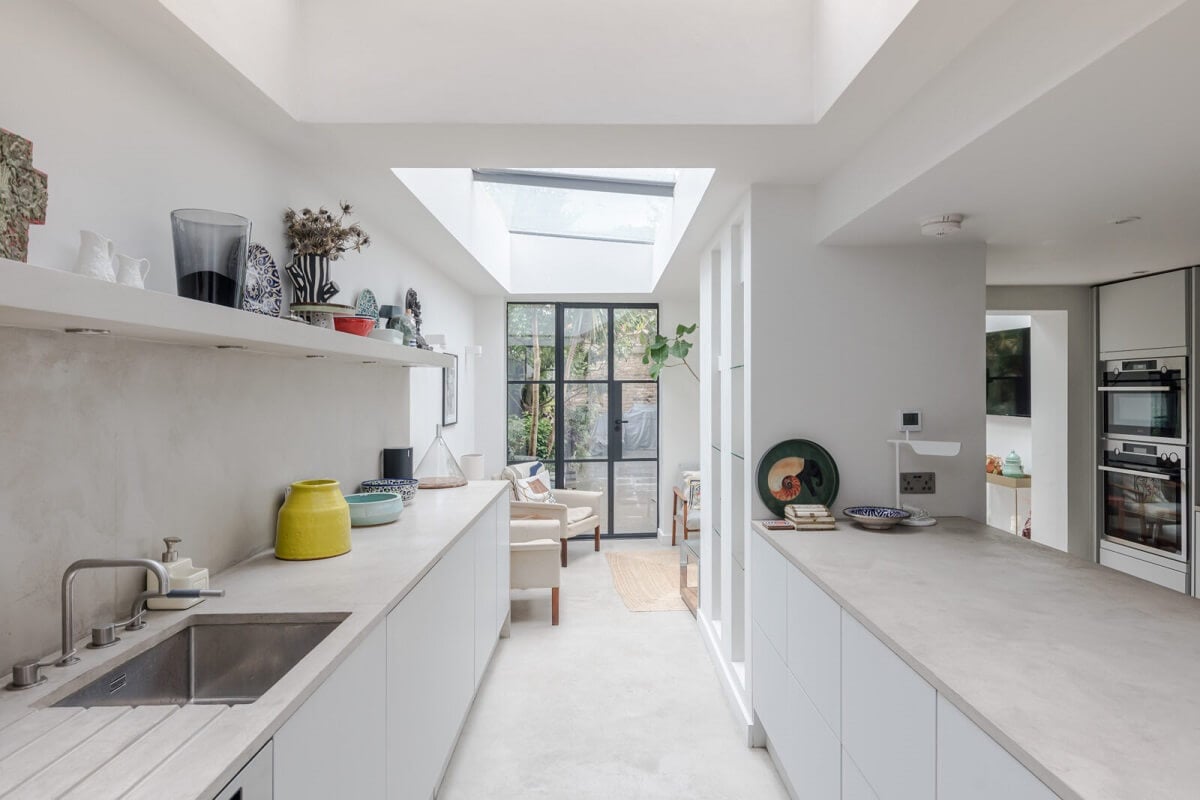 A Bright Extended and Renovated Victorian House in London 4 white kitchen extension with skylight