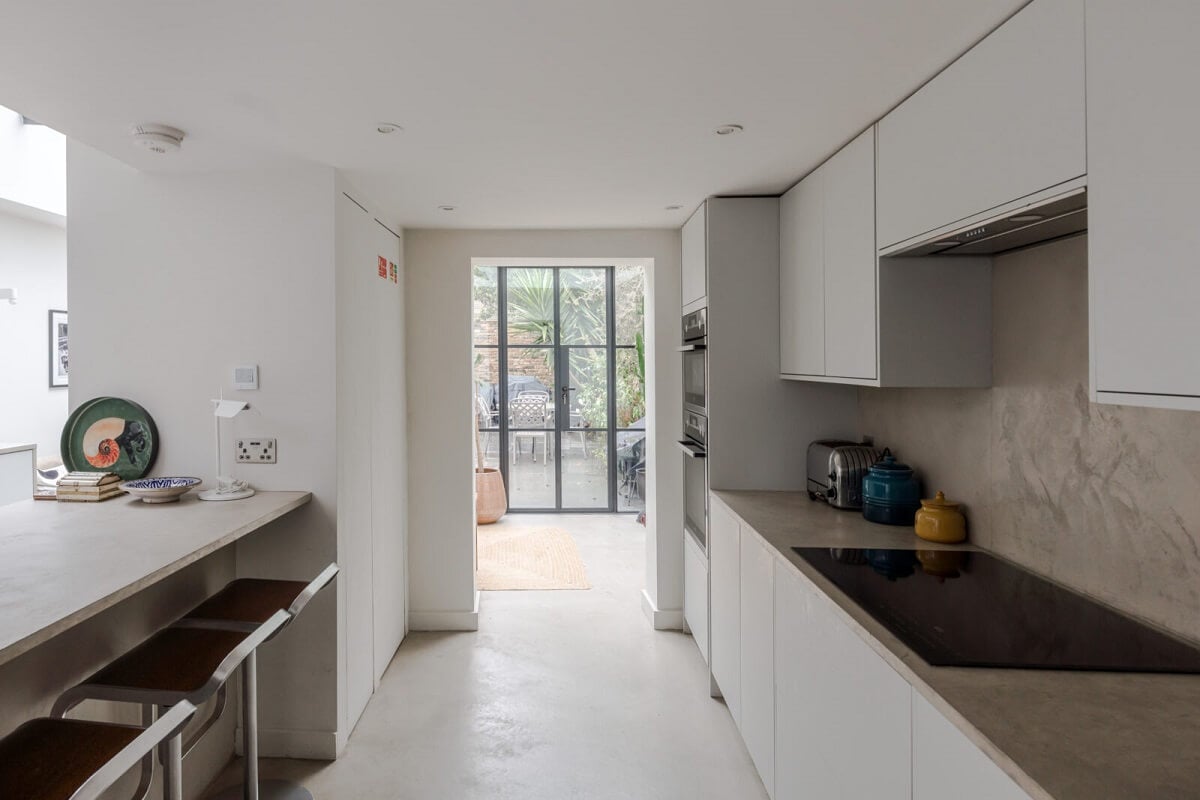 A Bright Extended and Renovated Victorian House in London 6 white kitchen with island