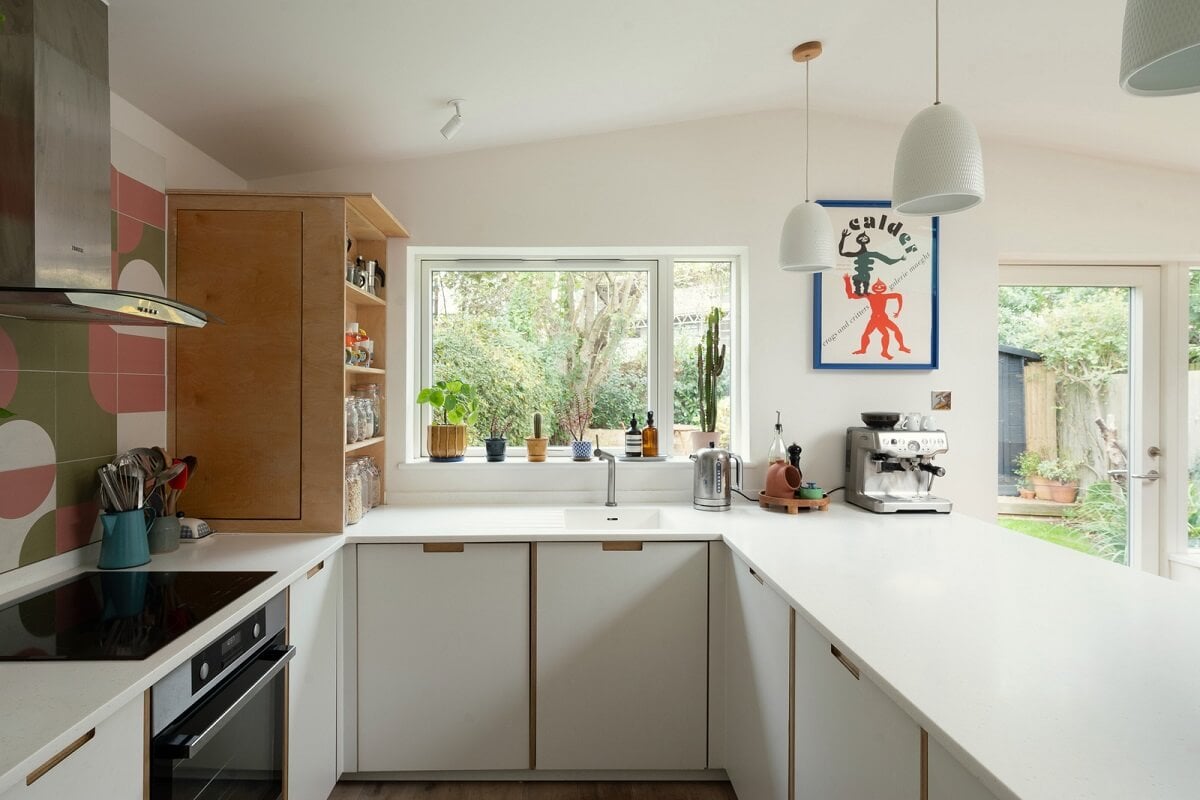 Colorful Rooms and Period Features in a London Terrace House 8 white u shaped kitchen