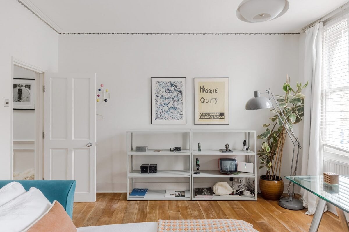 A Bright Extended and Renovated Victorian House in London 11 whte bedroom with desk and blue bed