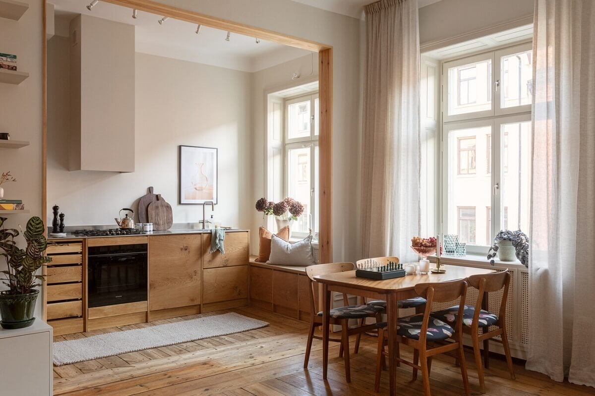 A Turn-of-the-Century Apartment with Warm Open-Plan Spaces 8 wooden dining table and open kitchen