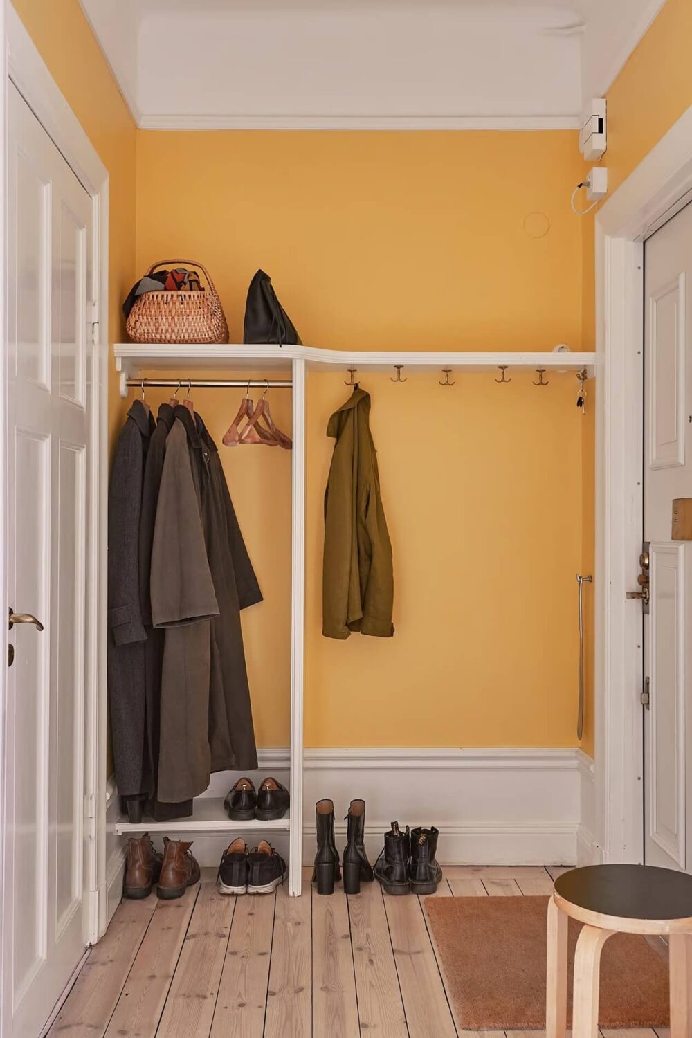 A Light Swedish Apartment with a Yellow Kitchen 21 yellow entry with coat storage
