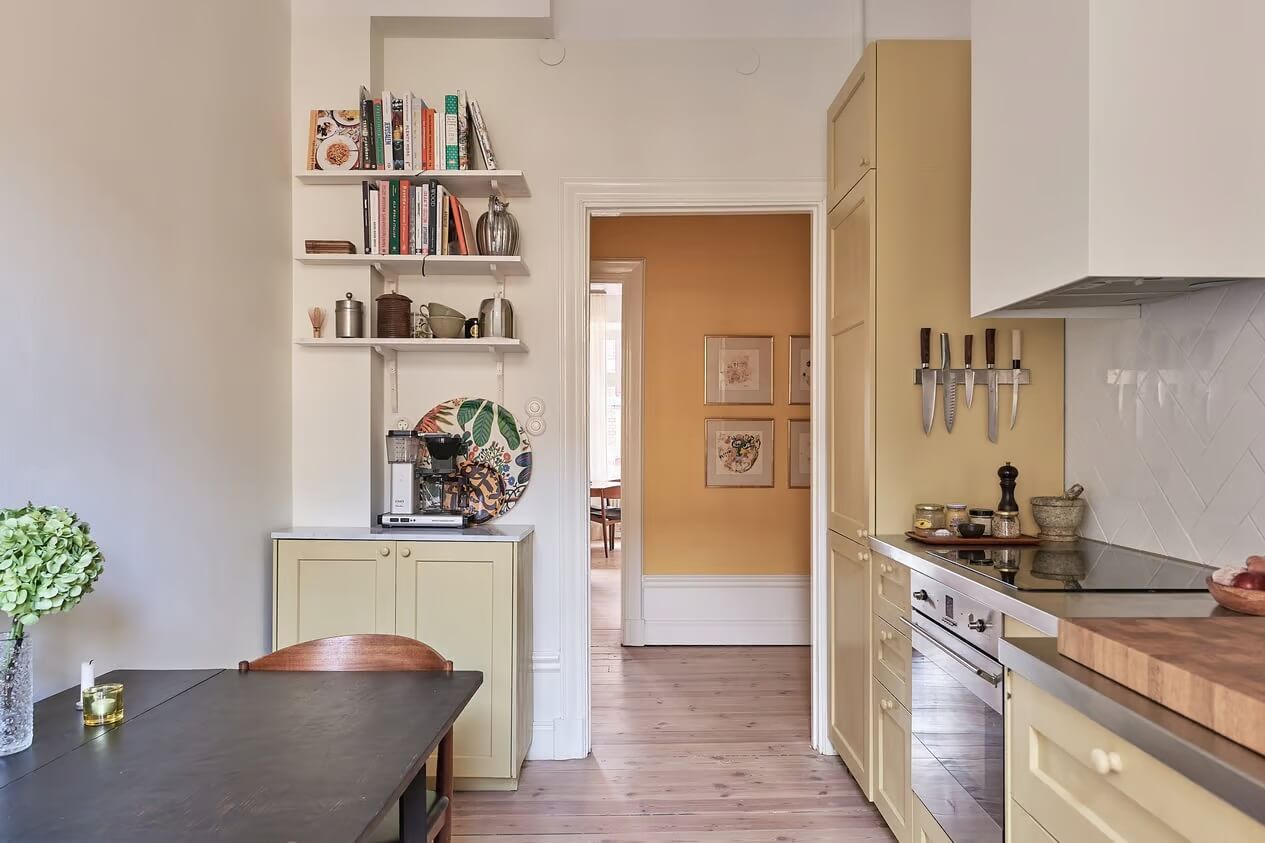 A Light Swedish Apartment with a Yellow Kitchen 18 yellow kitchen with table