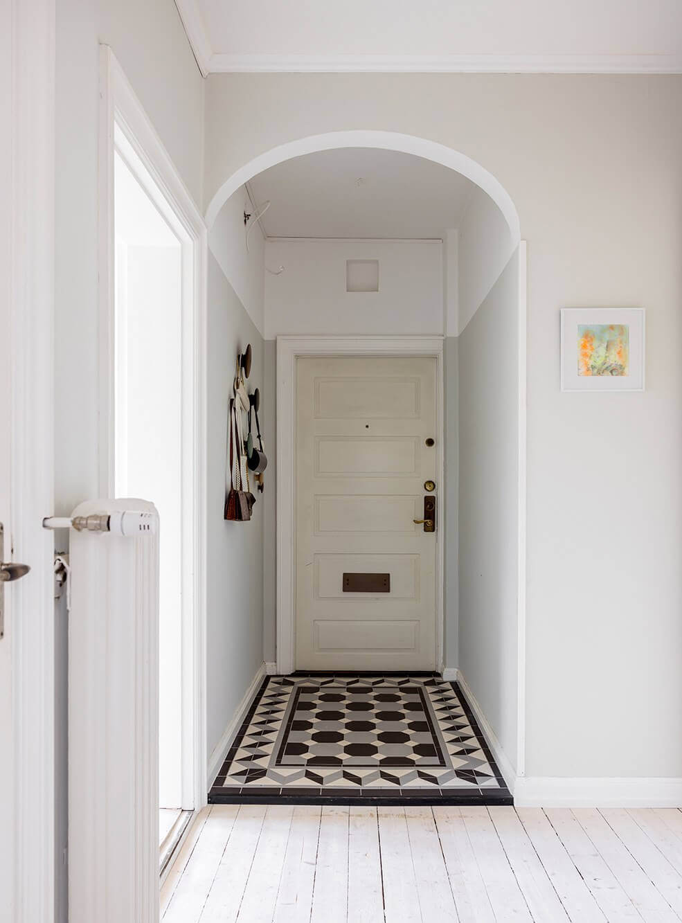 A Spacious Nordic Apartment with a Wonderful Color Palette 22 arched entry with floor tiles nordroom