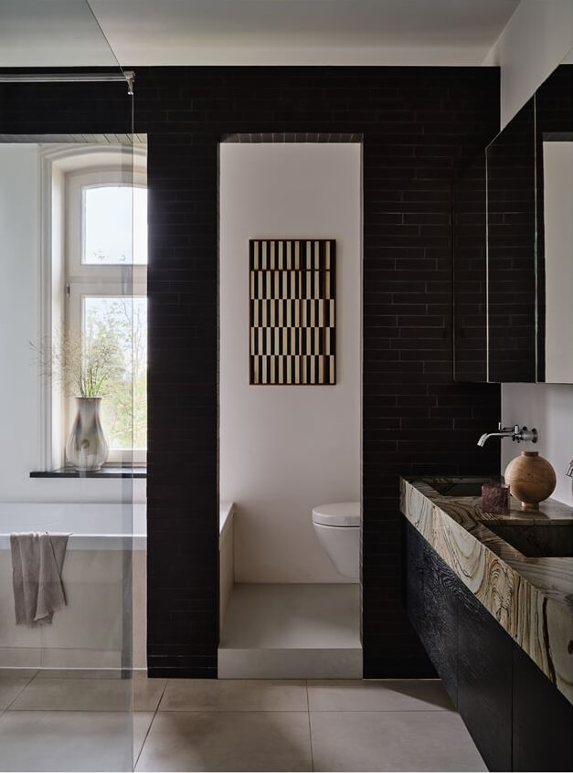 An Amazing Family Home in a Former Dutch Train Station 13 bathroom with dark tiles and marble sink nordroom