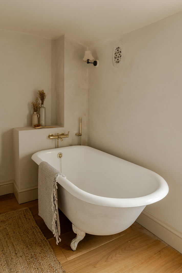 A Light Rustic Farmhouse-Style in an English Cottage 21 bathroom with freestanding bath and wooden floor nordroom