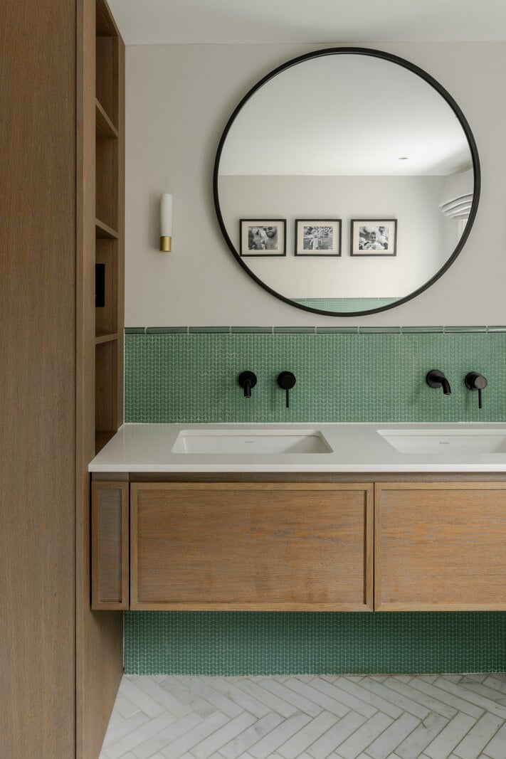 A Beautiful Extended Victorian Family Home in London 12 bathroom with oak vanity black fittings and green wall tiles nordroom