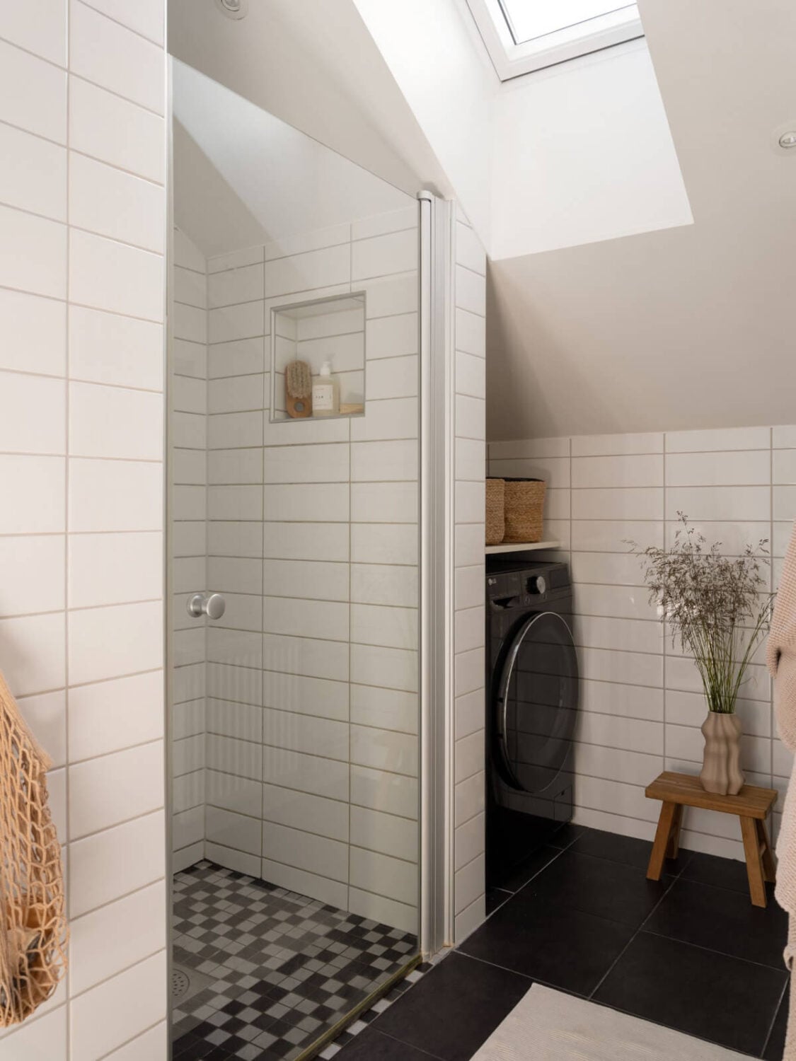 A Charming Light-Filled Attic Apartment with a Dark Oak Kitchen 19 bathroom with slanted ceiling