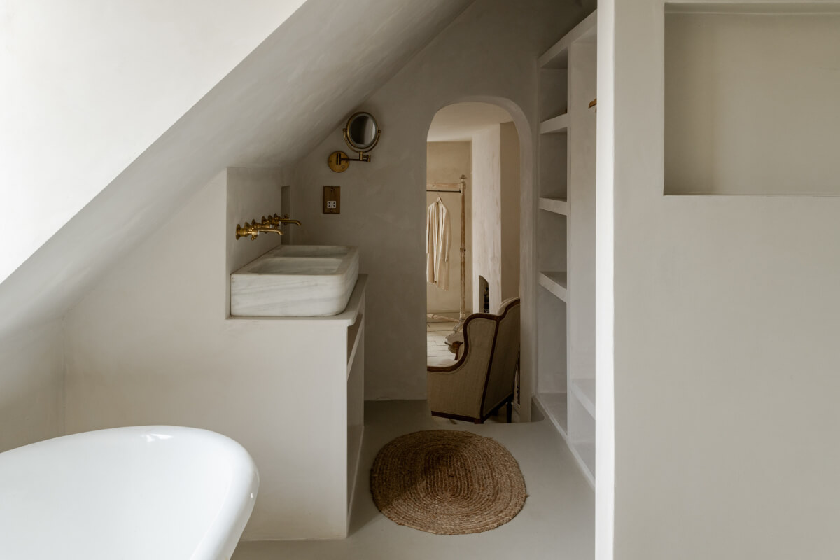 A Light Rustic Farmhouse-Style in an English Cottage 19 bathroom with slanted ceiling freestanding bath and double sinks nordroom