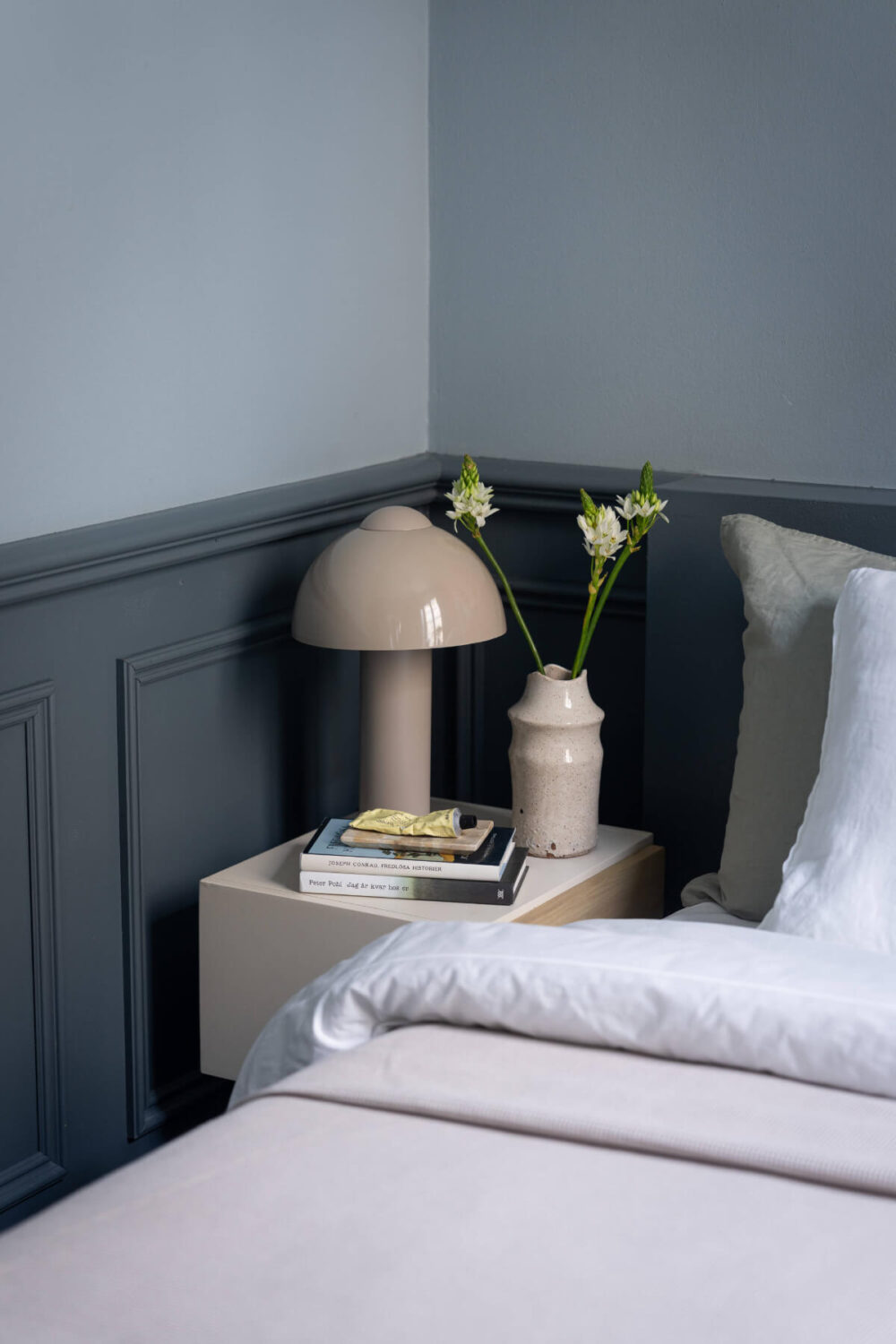 A Moody Color Palette in a Stylish One-Bedroom Apartment in Stockholm 11 bedroom nightstand