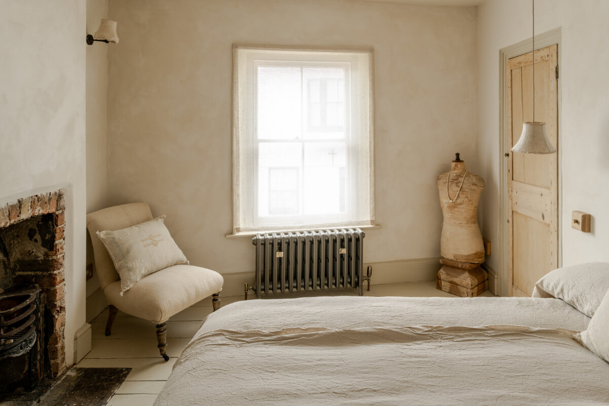 A Light Rustic Farmhouse-Style in an English Cottage 23 bedroom with brick fireplace and wooden floorboards nordroom